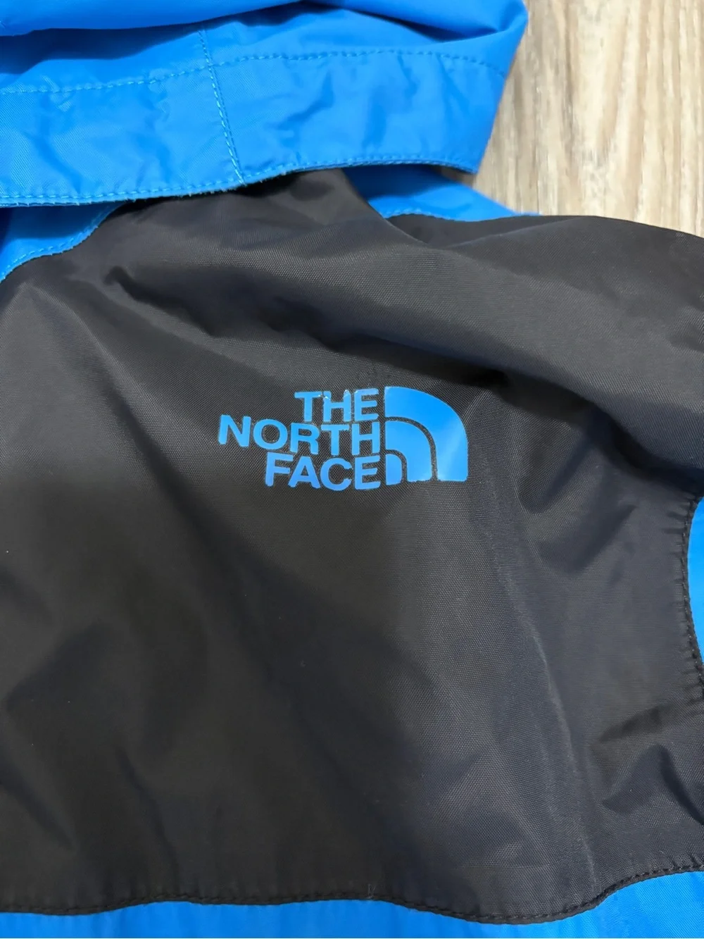 The North Face Blue and Black Hooded Rain Jacket